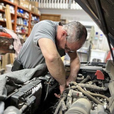 Mechanic diagnosing car